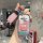 A hand holds a wuling starlight s car key cover featuring patrick star from spongebob, with a pink strap and a hi! speech bub...