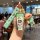 A hand holds a volkswagen passat b7 car key cover featuring a cartoon design with a green strap and a matching keychain, set ...