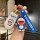 A hand holds a doraemon-themed car key shell case and accessories, featuring a white case with a doraemon print, a blue dorae...