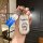 A hand holds a doraemon-themed car key shell case, featuring a blue and white design with the iconic character and doraemon t...
