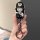 A hand holds a stylish aito m7 m9 key cover featuring a cute cartoon character in a black outfit, complete with a hat and a s...