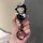 Hand holding a stylish black honda cr-v key cover featuring a cute cartoon character with bunny ears, holding a teddy bear, a...