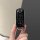 A hand holds a sleek, black mazda cx-4 key cover with a rubberized finish, featuring the mazda logo and three functional butt...