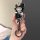 Hand holding a stylish lexus es200 key cover featuring a cute cartoon character in a hat, with a matching keychain and sleek ...