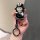 Hand holding a black toyota corolla cross key cover featuring a cute cartoon character with panda details, designed for rav4 ...