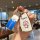 A hand holds a doraemon-themed key cover and fob, featuring a cheerful design with the iconic blue robot cat on a soft rubber...