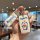 A hand holds a doraemon-themed key cover for land rover vehicles, featuring a cheerful doraemon design on a sleek aluminum ca...