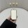 A hand holds a sleek, white kia k3 car key cover with a silver border, designed as a sporty silicone protector for the key sh...