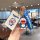 A hand holds a leapmotor c10 key cover featuring a doraemon design, including a 3d figure and a card holder, perfect for nfc ...