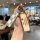 A hand holds a stylish wey vv7 car key cover featuring a checkered strap and a rectangular charm with chinese characters for ...