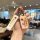 A hand holds a stylish changan lumin car key cover with and designs, featuring a leather strap and metallic finish, p...