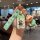 Hand holding a honda car key cover featuring a cartoon design with a crayon shin-chan theme, including a matching keychain an...