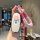 A hand holds a stylish denza d9 car key cover featuring a cute cartoon face design, pink rope keychain, and full protection s...