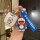 A hand holds a doraemon-themed car key cover set, featuring a bluetooth-ready carbon fiber shell case with a cute doraemon de...
