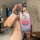 Hand holding a colorful patrick star-themed key cover for bmw 3 series, featuring a vibrant design and protective shell case....