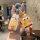 Hand holding a mercedes-benz c260l key cover featuring spongebob squarepants design, paired with a matching keychain charm, s...