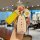 A hand holds a stylish hongqi hs5 car key cover with a yellow leather strap and a decorative flower charm, featuring the text...