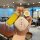 A hand holds a stylish wuling binguo car key cover featuring a yellow strap and a white flower charm, with the text and ...