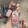 A hand holds a li auto key cover featuring patrick star from spongebob, with a pink leather strap and a hi! speech bubble, de...