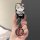 A hand holds a volkswagen magotan b8 car key cover featuring a cute hello kitty design with floral accents and a stylish outf...