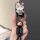 A hand holds a stylish volkswagen magotan b8 key cover featuring a cute hello kitty design with floral accents, paired with a...