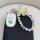 Aima electric scooter key cover featuring a playful flower design with a pastel color scheme, complemented by a matching bead...