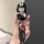 A hand holds a stylish black key cover featuring a cute cartoon character in a hat, paired with a get rich keychain, designed...