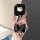 A hand holds a sleek black lynk & co key cover featuring a cute hello kitty design, adorned with a shiny black bow and a silv...