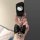 A hand holds a sleek black chery ant key cover featuring a hello kitty design, adorned with a shiny black bow and a silver he...