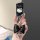 A hand holds a lexus key fob with a hello kitty design, featuring a black bow and heart charm. this stylish key cover is perf...