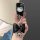 A hand holds a stylish black key cover featuring a hello kitty design, adorned with a glittery bow and a shiny heart charm. p...