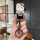 A hand holds a stylish hello kitty-themed key cover for honda uhr150/ufr150 motorcycles, featuring a cute design with flowers...