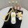 A hand holds a porsche car key cover featuring a white and silver design with cute bear charms, including a teddy bear with w...