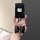 A hand holds a black huawei aito m5 ev m7 car key cover featuring a hello kitty design, adorned with a glittery bow and a hea...