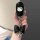 A hand holds a sleek black nio es8 card key cover featuring a white hello kitty design, adorned with a shiny black bow and si...