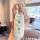 A hand holds a white gac aion y plus key cover featuring doraemon designs, including icons and the characters face, set again...