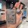 A hand holds a changan deepal sl03 car key cover featuring a cartoon bear with the text good luck, lets get rich and a lucky ...