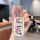 A hand holds a volkswagen jetta car key cover featuring a white carbon fiber shell case with colorful crayon shin-chan cartoo...