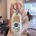 A hand holds a white buick gl8 car key cover featuring a cute little snow princess design with a cartoon character and decora...