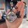 A hand holds a wuling bingo car key cover featuring a playful cartoon design with the text so and a cute black animal ...