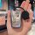 A hand holds a sleek, metallic key cover featuring a cartoon dog with the text so excited to get rich, designed for bmw 5 ser...