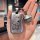 A hand holds a roewe rx5 plus car key cover featuring a cartoon dog and the text good luck, about to get rich. it includes a ...