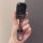 A hand holds a sleek black volkswagen lavida car key cover, featuring a glossy finish and a matching keychain with the vw log...