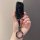 A hand holds a sleek, black bmw car key cover with a knife-edge shell design, featuring a reflective surface and a decorative...