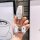 A hand holds a ford escape key cover featuring a white and gold design with a butterfly charm, showcasing a durable 3-button ...