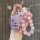 A hand holds a pink, glittery key cover for toyota land cruiser models like prado, crown, and prius, adorned with a beaded ch...
