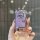 A hand holds a toyota land cruiser key cover, featuring a sparkling purple design with silver accents and a sleek, protective...