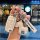A hand holds a volkswagen key fob with a stylish white leather cover featuring a rocking horse charm and a vw logo, set again...
