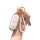 A hand holds a sleek, white ideal l8 key cover with gold accents, featuring a braided leather keychain and a decorative tag, ...