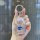 A hand holds a sparkling subaru key cover tpu, featuring a blue subaru logo and a glittery finish, designed for forester, out...